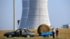 Belarus - People transporting a bundle of straw close to the construction site of the first Belarus' nuclear power plant outside the town of Astravets, some 170 km northwest of Minsk, 19Aug2017